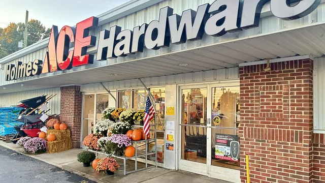 Holmes Ace Hardware storefront at 1905 Charlestown Rd in New Albany, with fall mums and pumpkins at the entrance